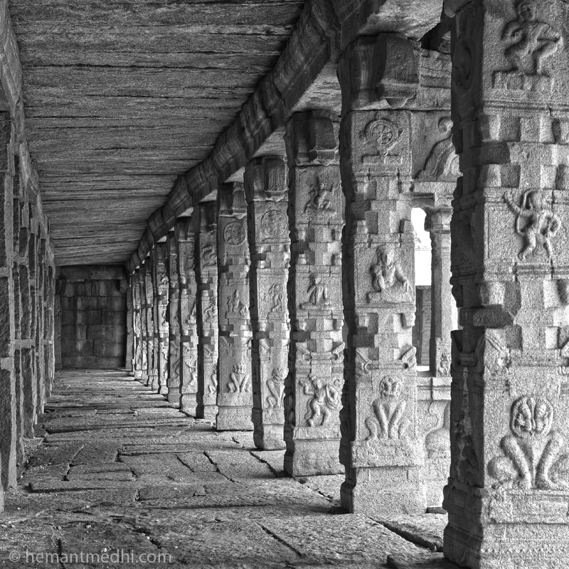 Stone Carved Pillers passage in a temple. Hampi. (0483Hampi) A World Heritage Site situated in  Karnataka, India. This is located at Actutray Temple, Hampi. A Unesco World Heritage Site.  Indian Heritage, Art and Culture.  Fine Art Photography on Canvas Printing Indian Temples Fine Art Culture Carving Stone Black and White black&white B&W World Heritage Site BW Hampi 