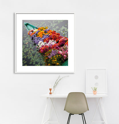 Ladakh is most famous for breathtaking landscapes, the crystal clear skies, the highest mountain passes, thrilling adventure activities, Buddhist Monasteries and festivals. (_MG_5365 Ladakh Col)   This Fine Art Photograph is printed on Canvas. Colourful Flowers in a boat